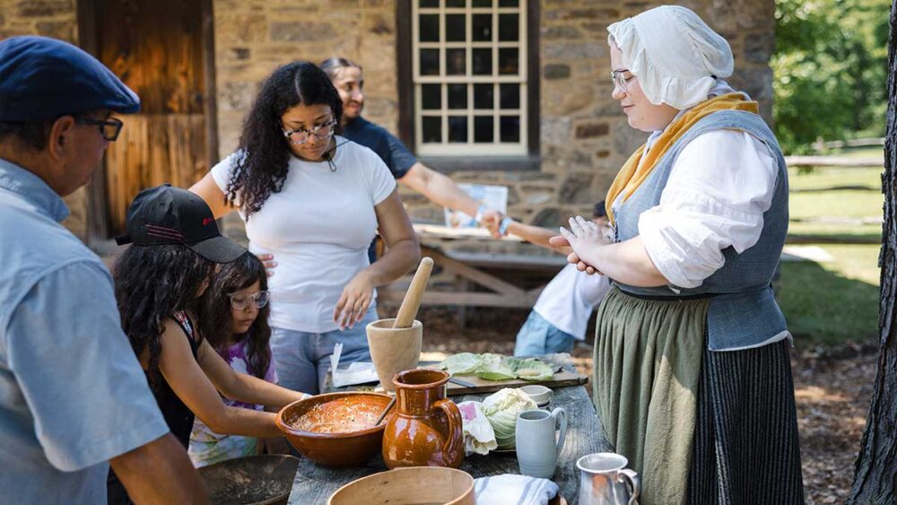 Global Grains Demonstration A woman in historic costume demonstrated cooking techniques